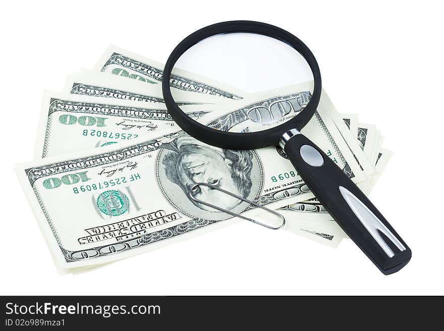 Bills of the dollars and magnifying glass on white background