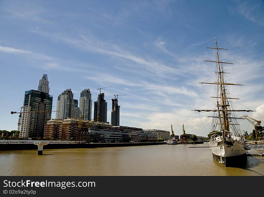 The 112 year old Sarmiento Frigate now shares the river with newly constructed high rises - Buenos Aires, Argentina. The 112 year old Sarmiento Frigate now shares the river with newly constructed high rises - Buenos Aires, Argentina.