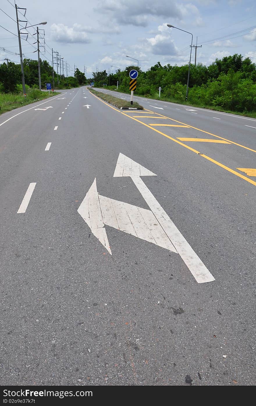 Arrow traffic symbol on asphalt road. Arrow traffic symbol on asphalt road