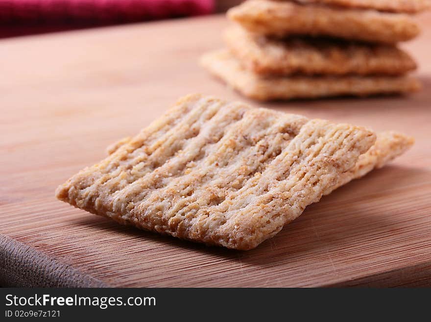 Wheat crackers on a kitchen board - a light meal.