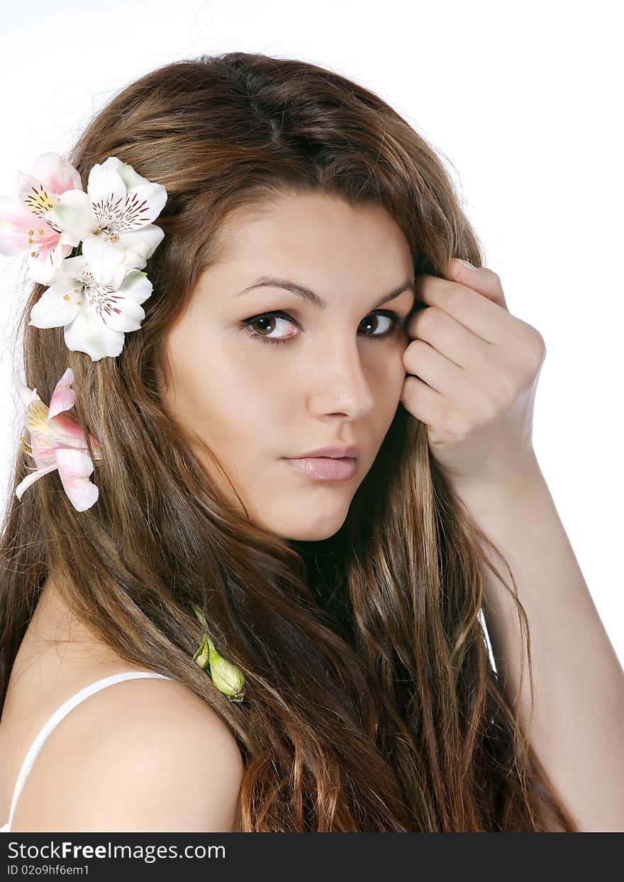 Studio portrait of beautiful young girl with flowers in hair. Studio portrait of beautiful young girl with flowers in hair