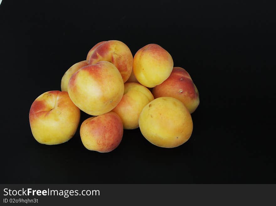 Ripe apricots in isolated over black