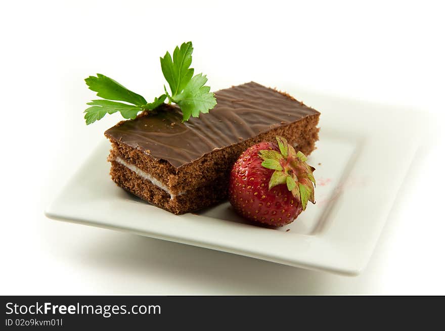 Chocolate cake with strawberries is depicted on a white background