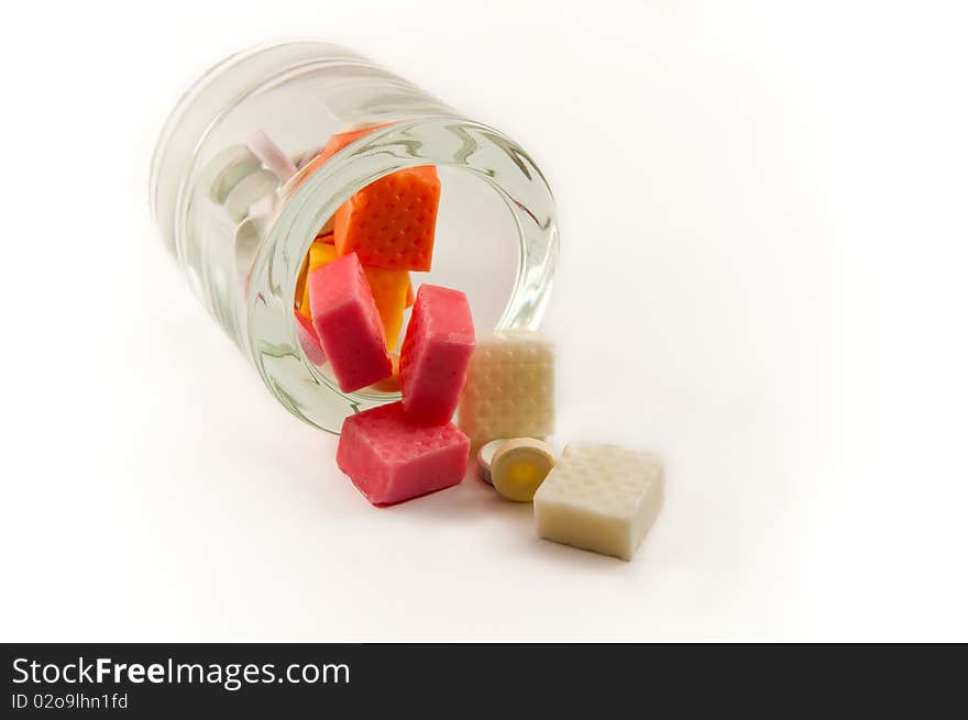 Sweets fell from the glass. All of this is shown on a white background. Sweets fell from the glass. All of this is shown on a white background.