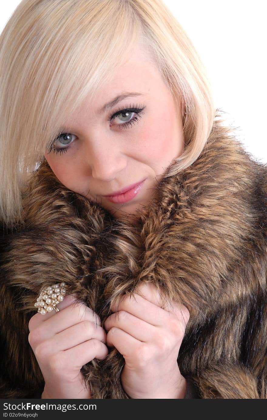 Sexy smiling blond wearing fur coat