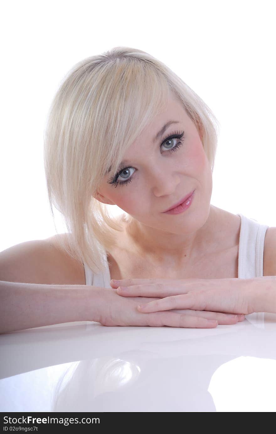 Photograph showing beautiful young blond woman in high key portrait isolated against white. Photograph showing beautiful young blond woman in high key portrait isolated against white