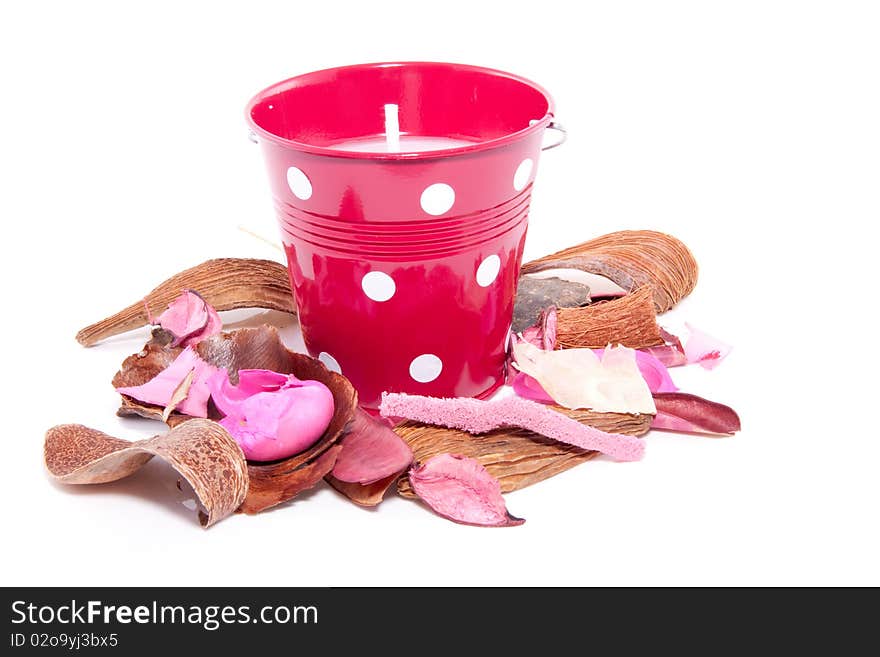 Colorful potpourri and a red candle in a bucket isolated over white. Colorful potpourri and a red candle in a bucket isolated over white