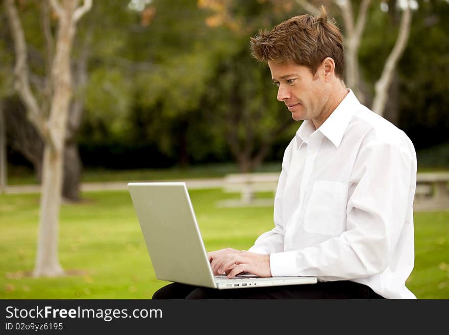 Man looking at his laptop outside. Man looking at his laptop outside