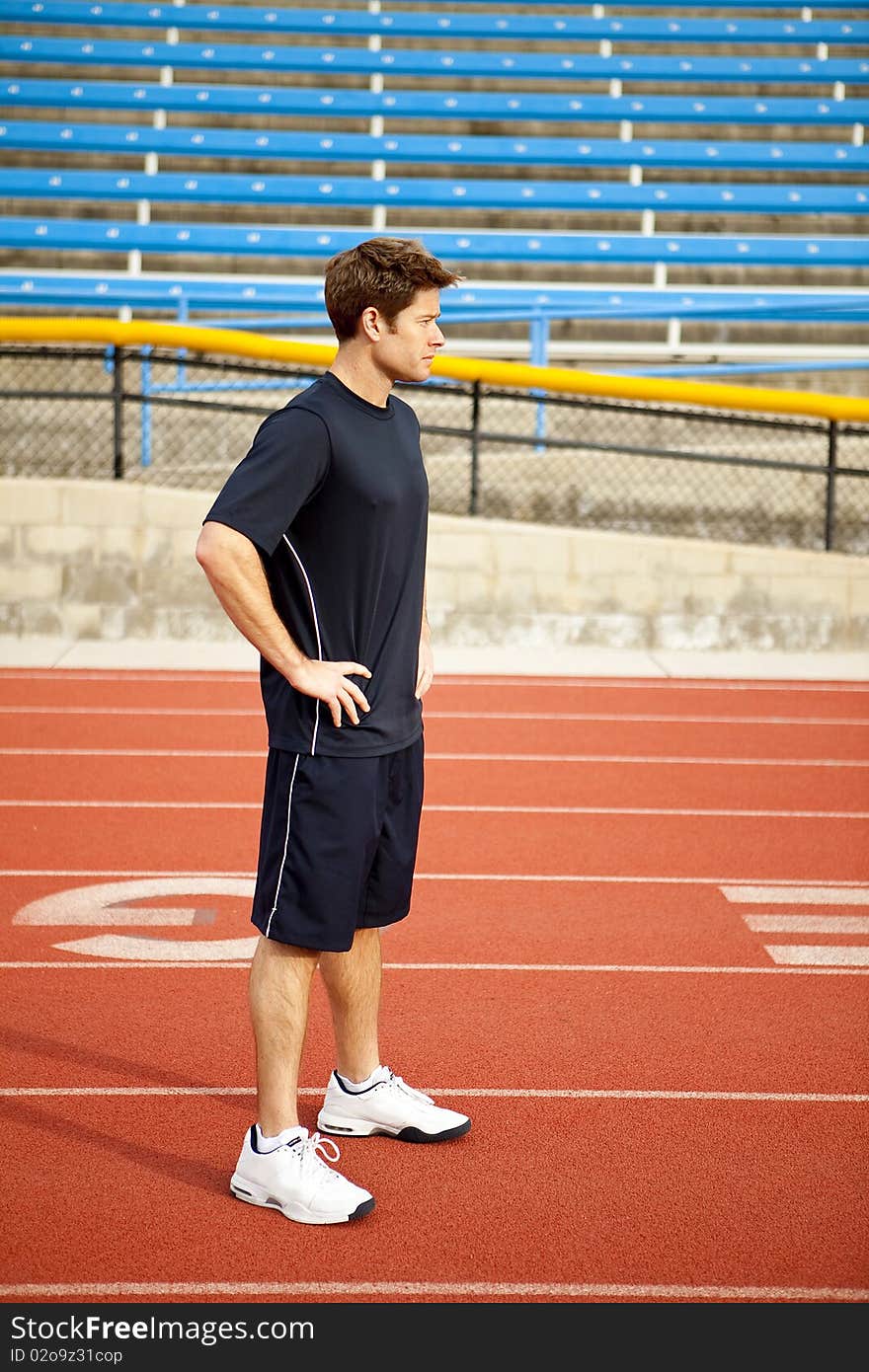 Man standing on a track outside. Man standing on a track outside