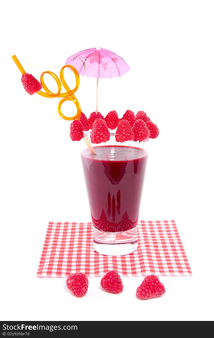 A fresh made glass of red fruit juice nicely decorated isolated over white. A fresh made glass of red fruit juice nicely decorated isolated over white