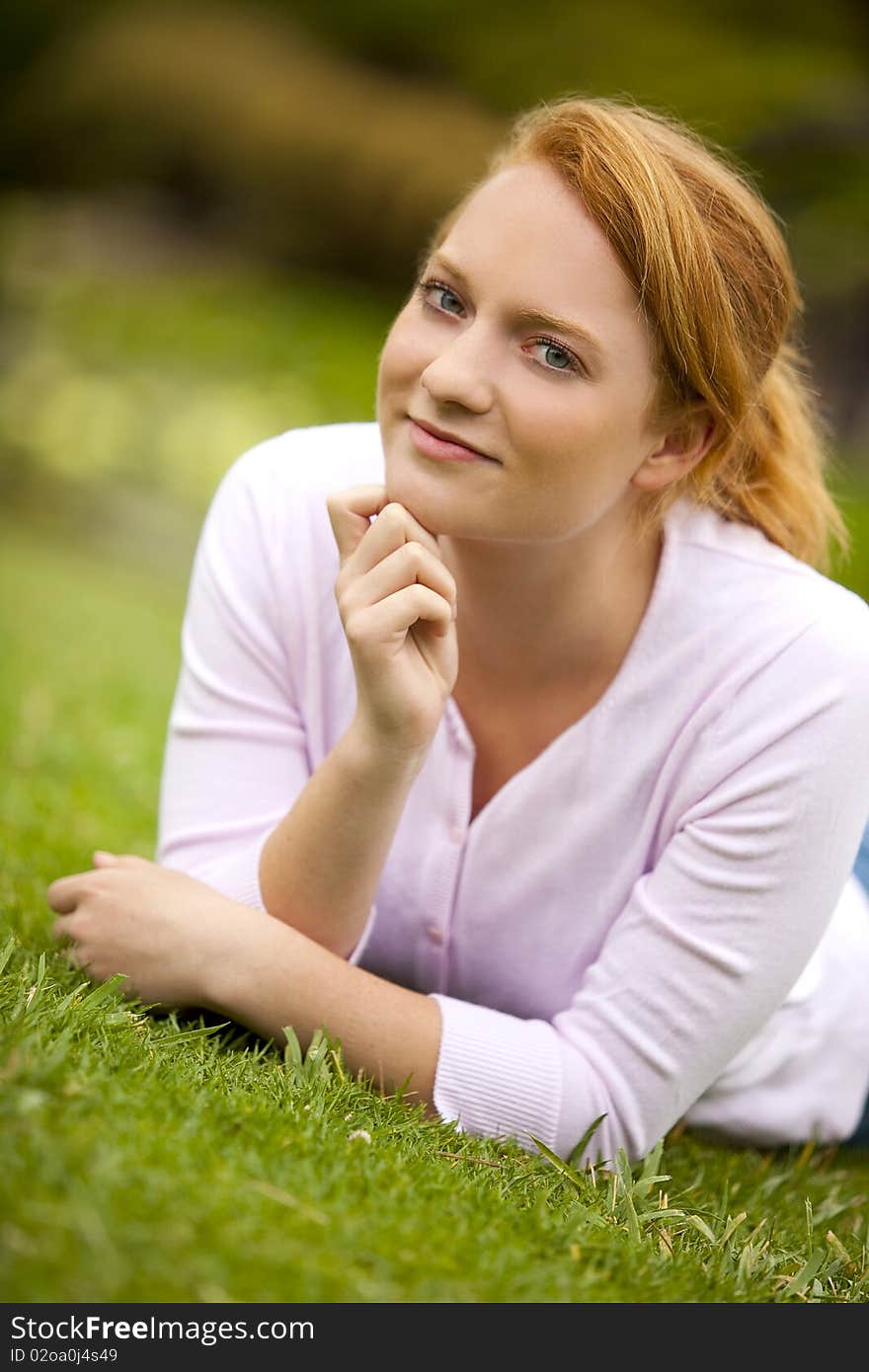 Pretty young woman sitting outside