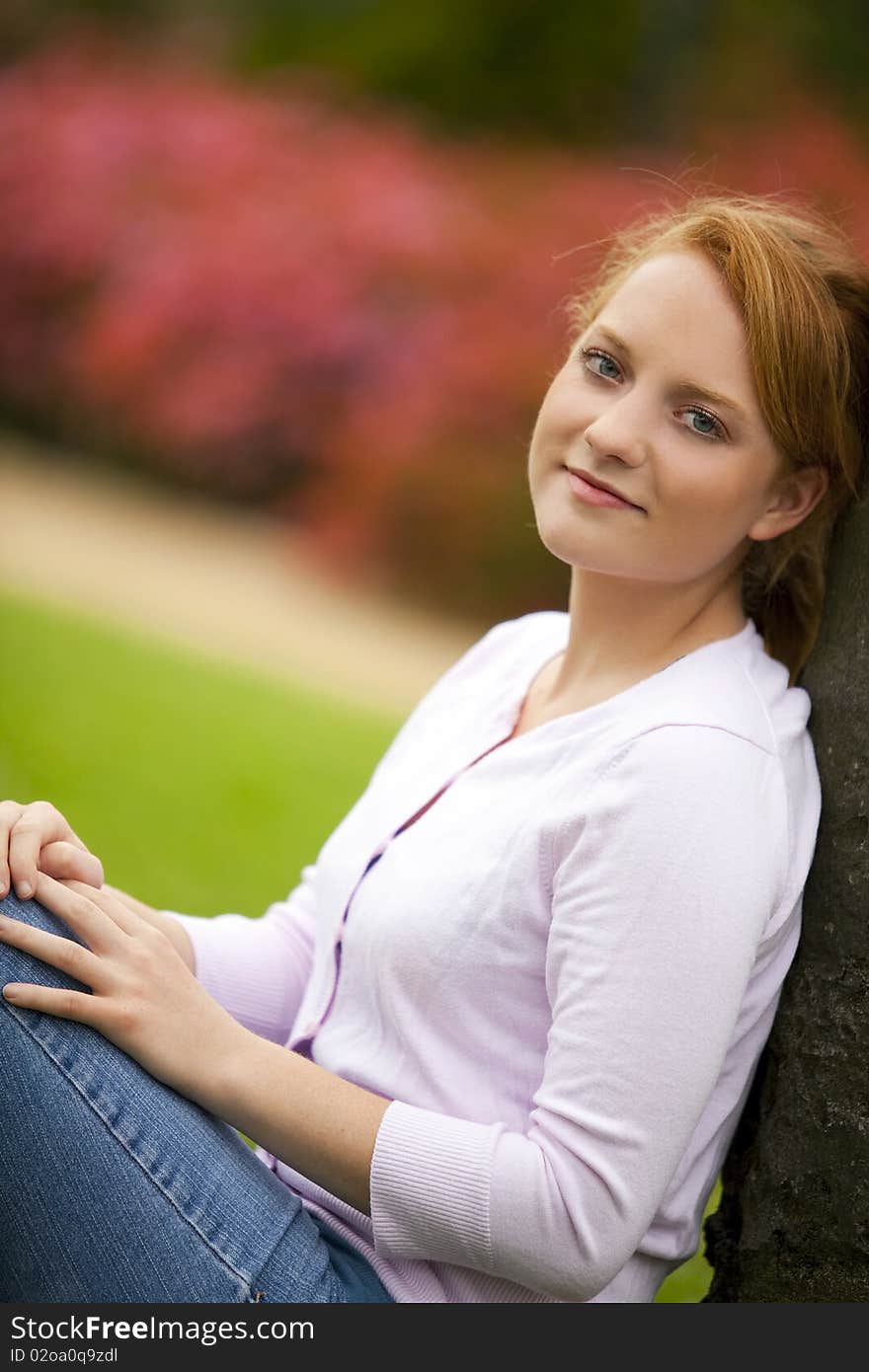 Pretty young woman sitting outside