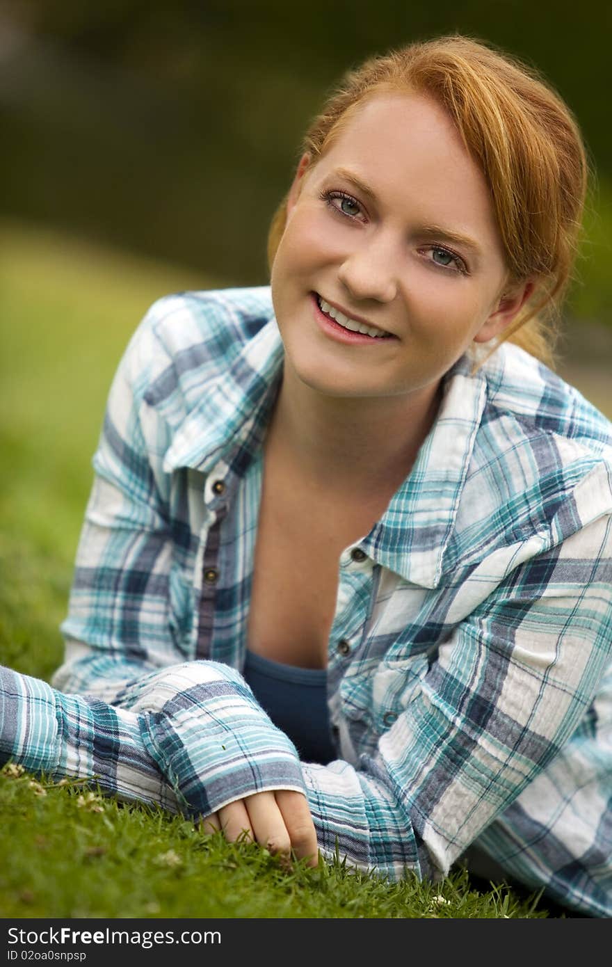 Pretty young woman sitting outside