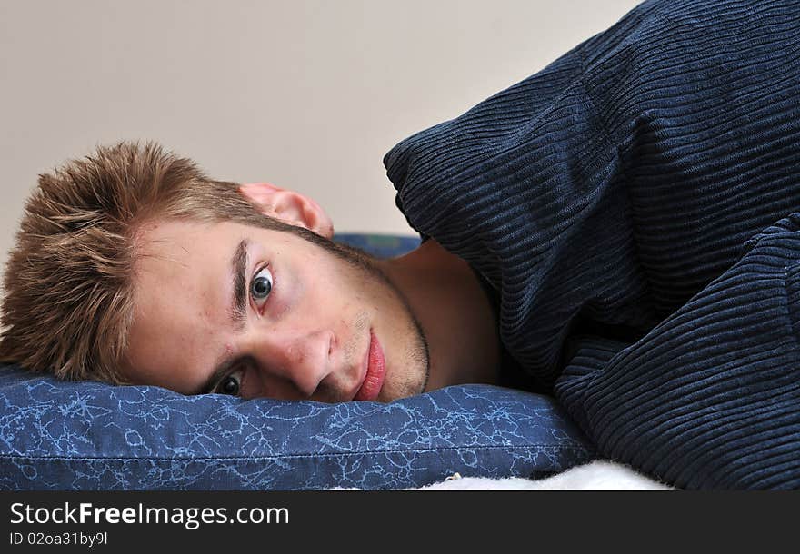 Young Caucasian teenage adult male sleeping on his pillow with his eyes closed. Young Caucasian teenage adult male sleeping on his pillow with his eyes closed.