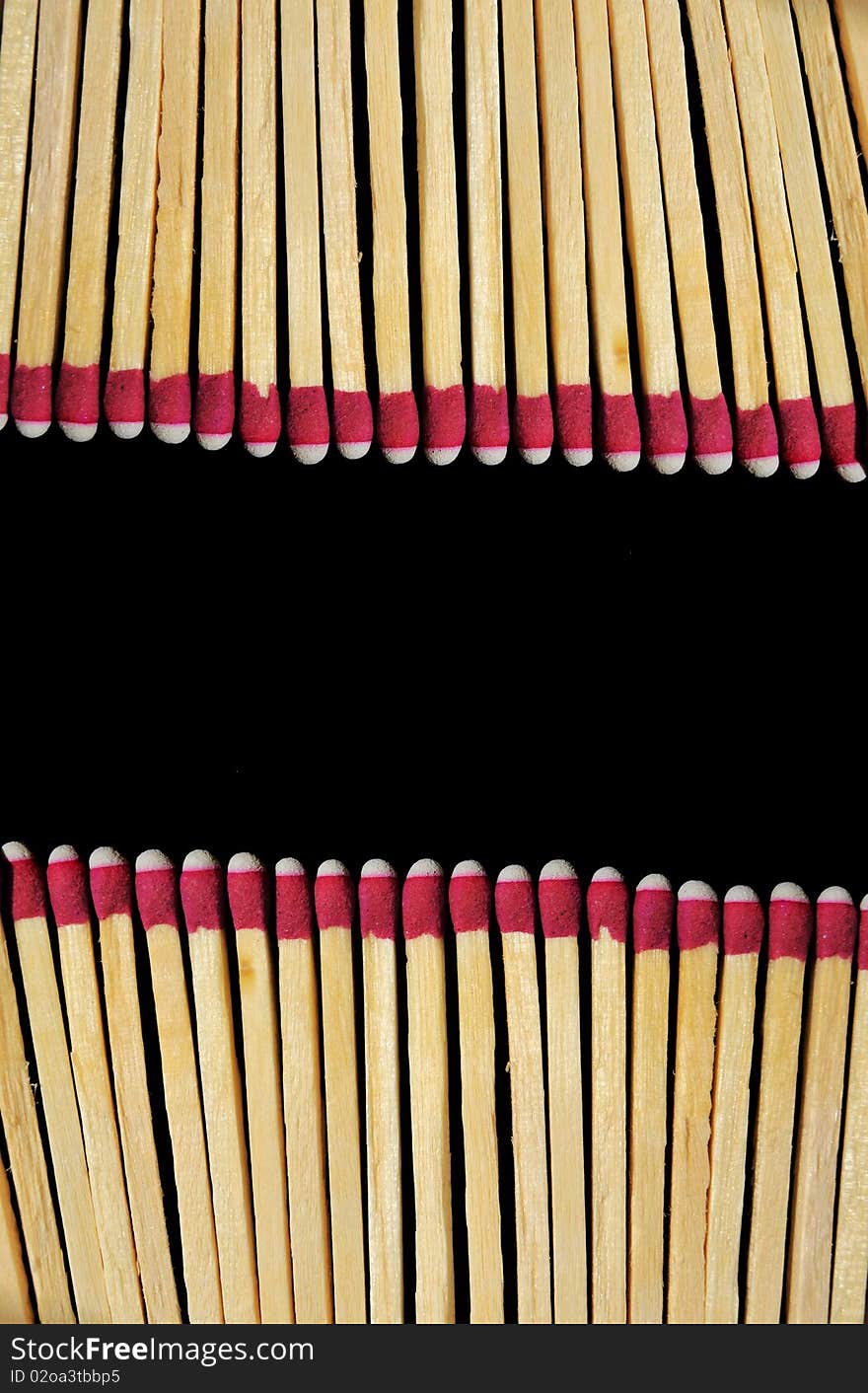 A bunch of wooden matches isolated on a black background. A bunch of wooden matches isolated on a black background