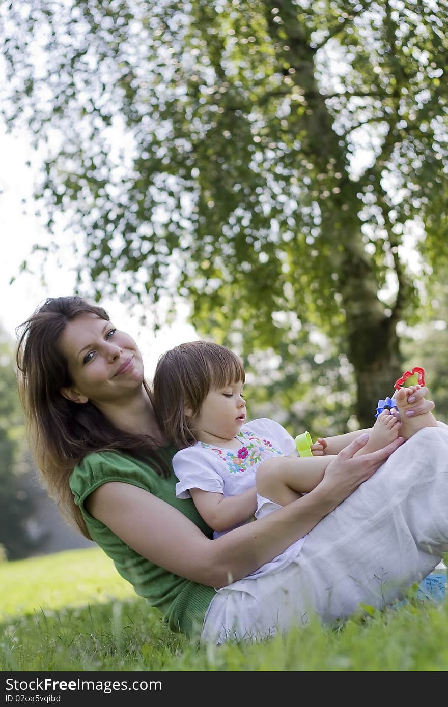 Mother and daughter together in park. Mother and daughter together in park