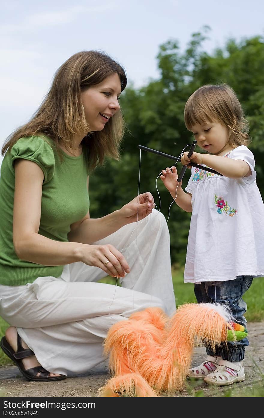 Happy mother and daughter playing together in park