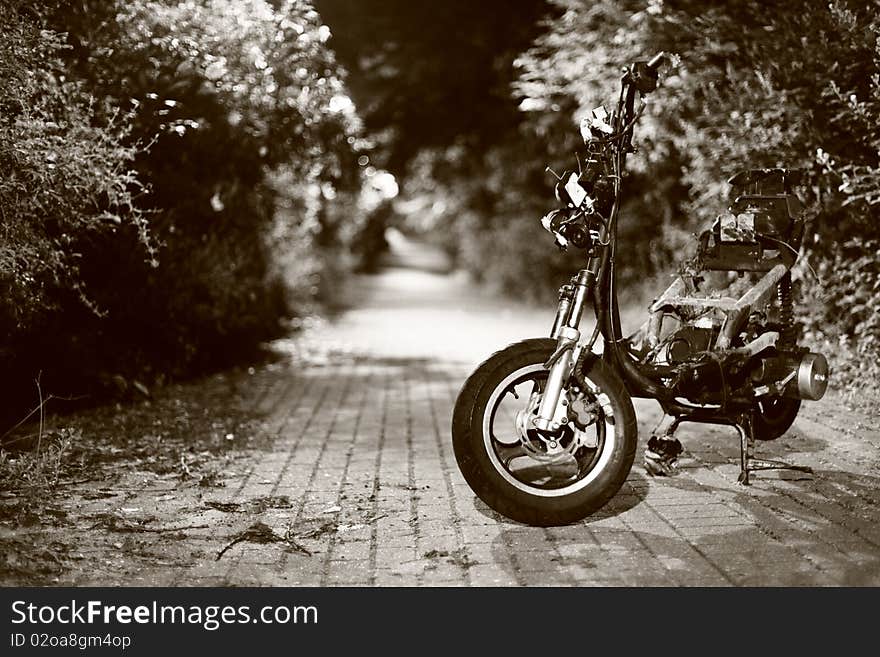 A burned motorbike left on a walkway. A burned motorbike left on a walkway.