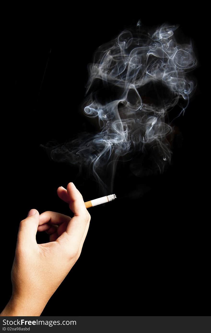 Hand holding a cigarette with deadly smoke.