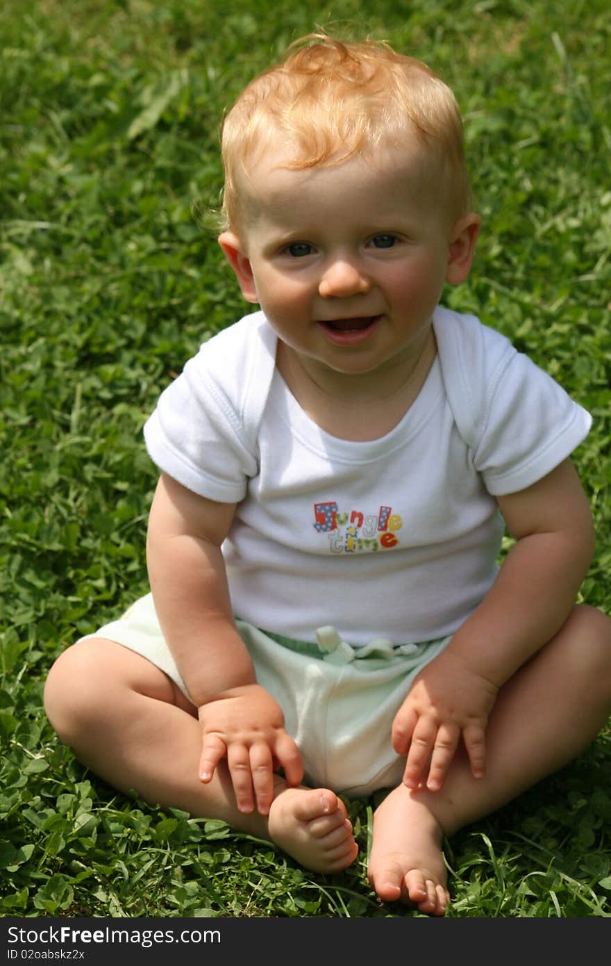 Small red hair boy having a grass sit. Small red hair boy having a grass sit