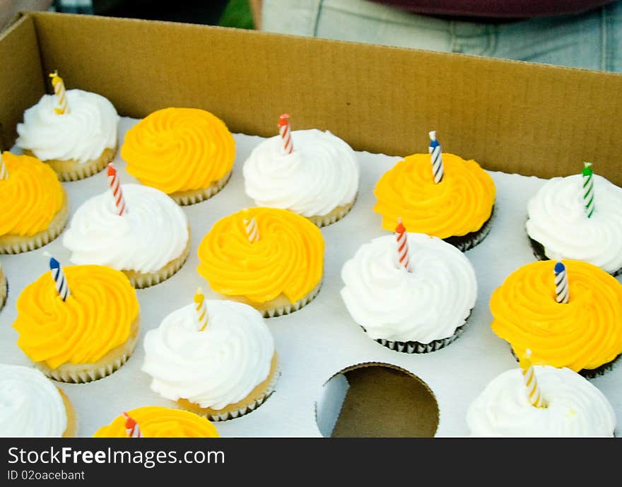 Yellow and white birthday cupcakes