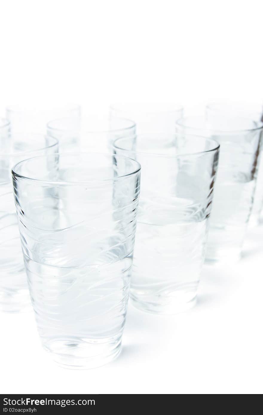 Photo of too many glasses of water half full. Photo of too many glasses of water half full