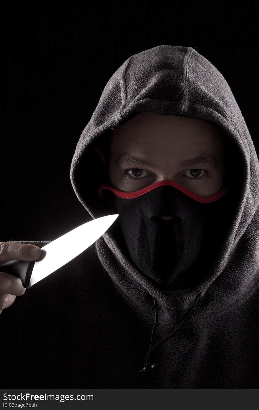 Man with knife and hoody, concept of danger. Man with knife and hoody, concept of danger