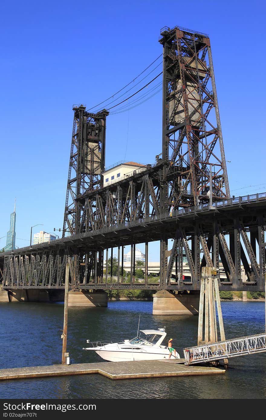 The steel bridge against a blue sky and a moored yacht on the Willamette river. The steel bridge against a blue sky and a moored yacht on the Willamette river.