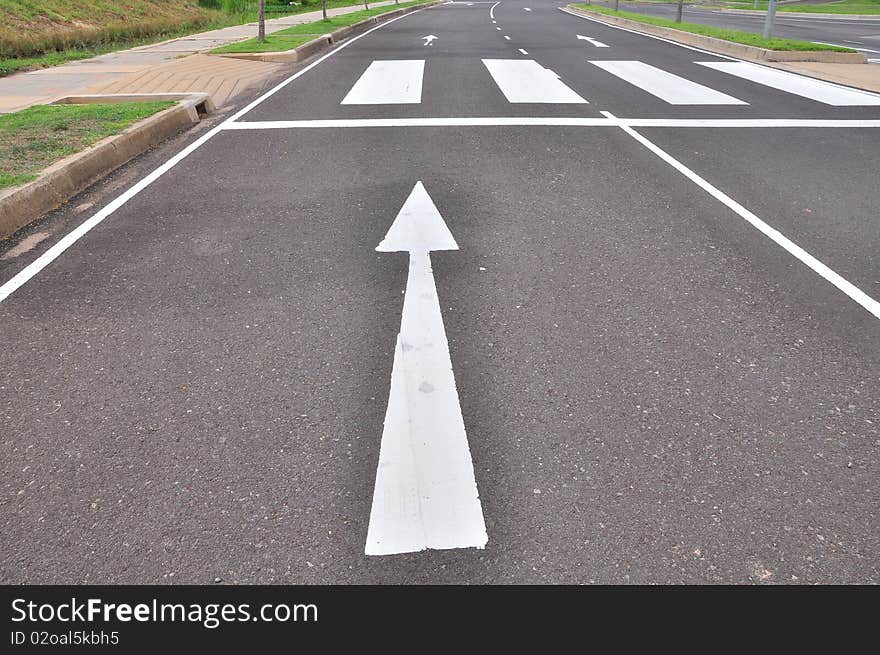 Arrow traffic symbol in asphalt road