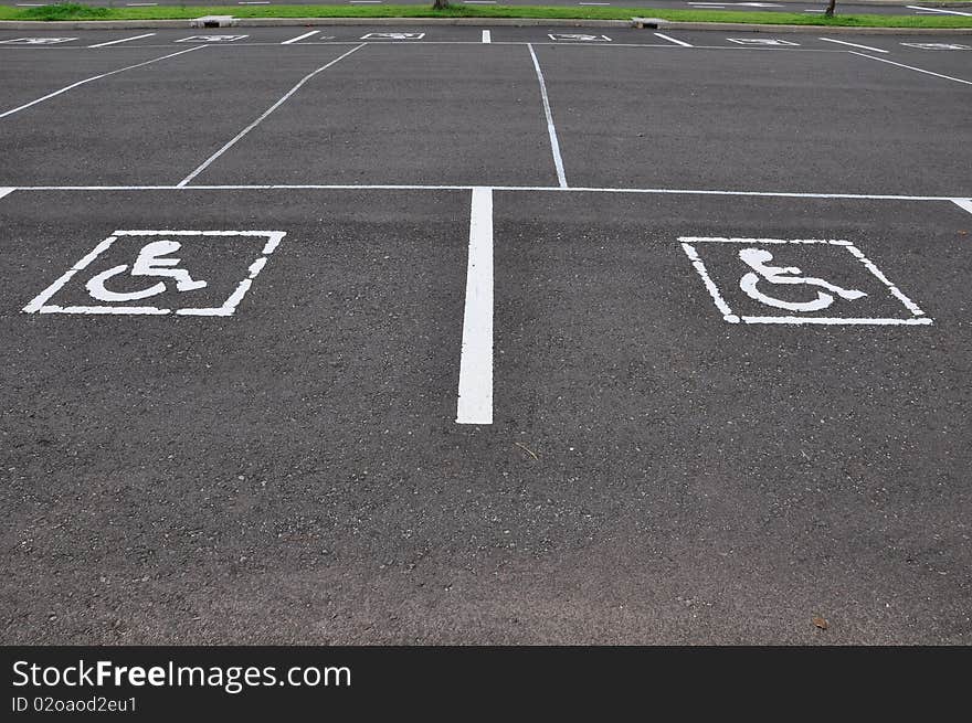 Wheel chair symbol with asphalt road