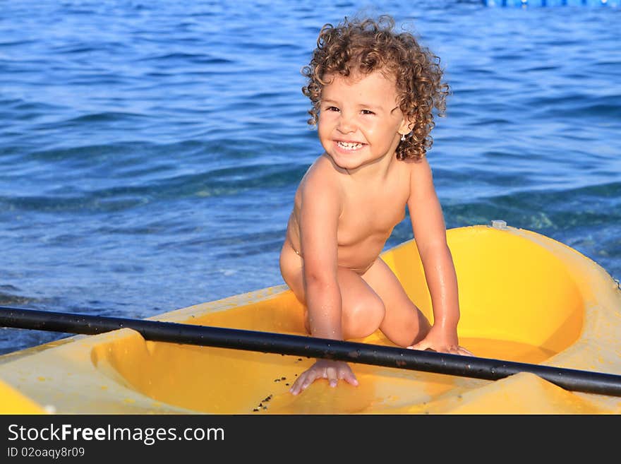 Baby girl in canoe and sea. Baby girl in canoe and sea
