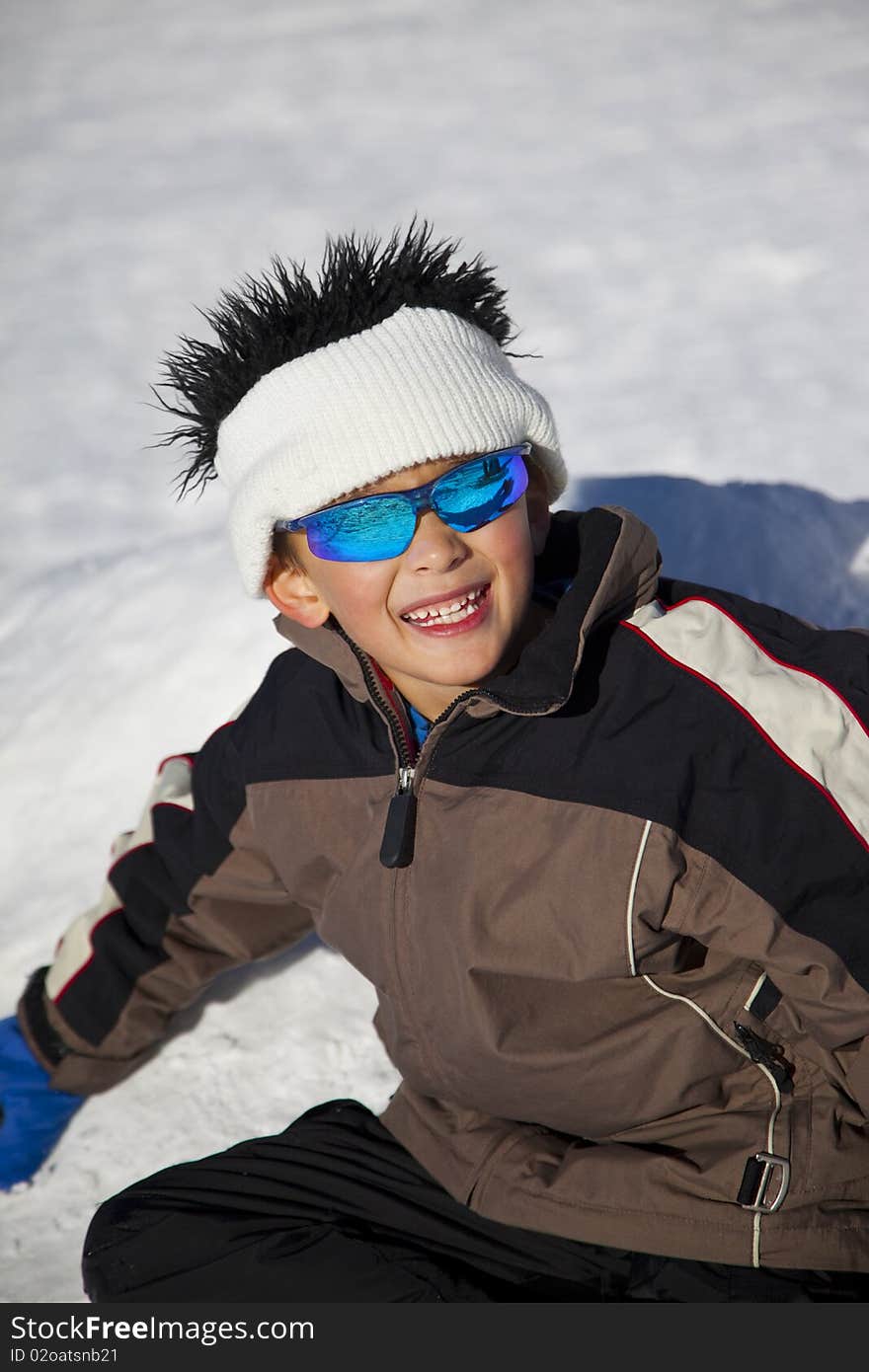 Young Boy With Fun Beanie On Snow