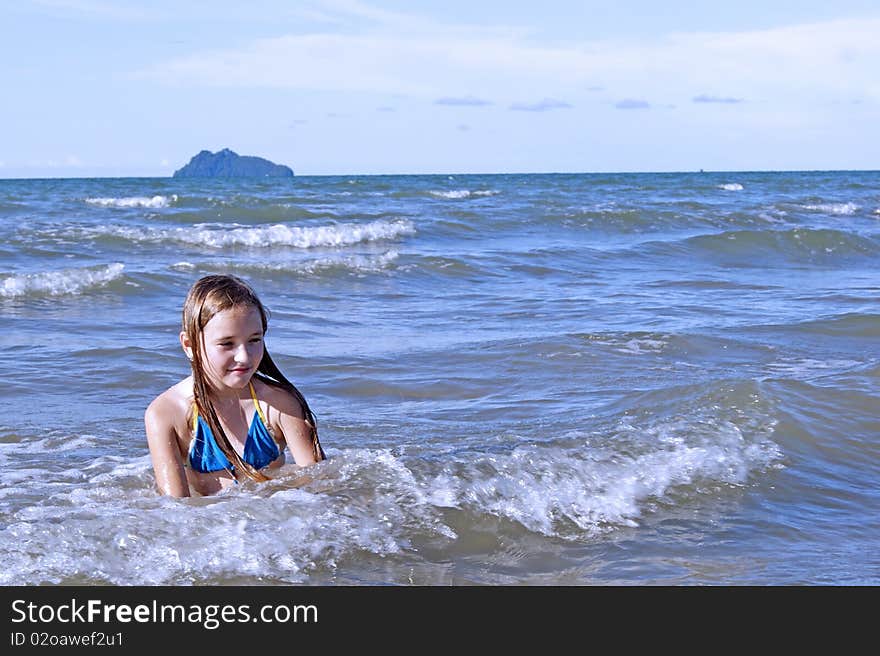 The girl learns to swimm in the sea. Southern - Chinese sea. Coast Borneo. Day.