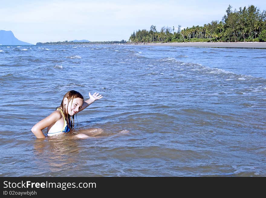 The girl learns to swimm in the sea. Southern - Chinese sea. Coast Borneo. Day.