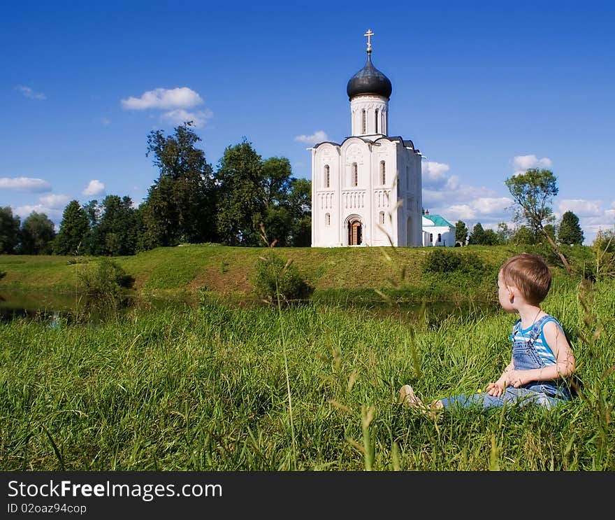 Little boy on a orthodox church background. Church of the Intercession on the Nerl (Vladimir region of Russia). Little boy on a orthodox church background. Church of the Intercession on the Nerl (Vladimir region of Russia)