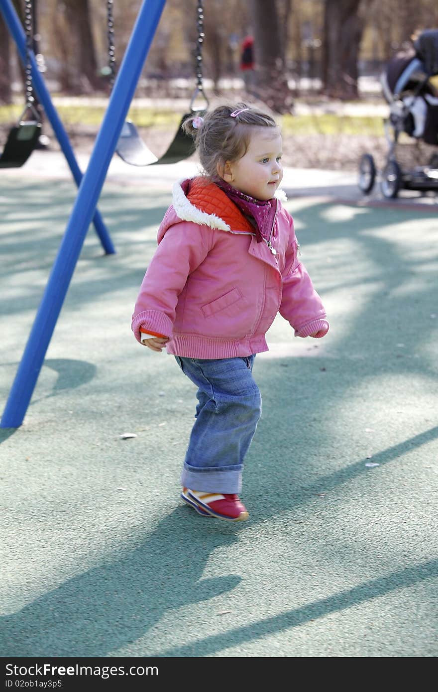 Running young girl on outdoor playground. Running young girl on outdoor playground