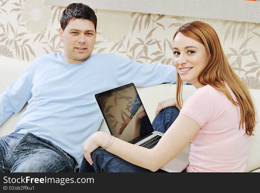 Young couple at home with  modern livingroom indoor working on laptop on house finance and planing. Young couple at home with  modern livingroom indoor working on laptop on house finance and planing