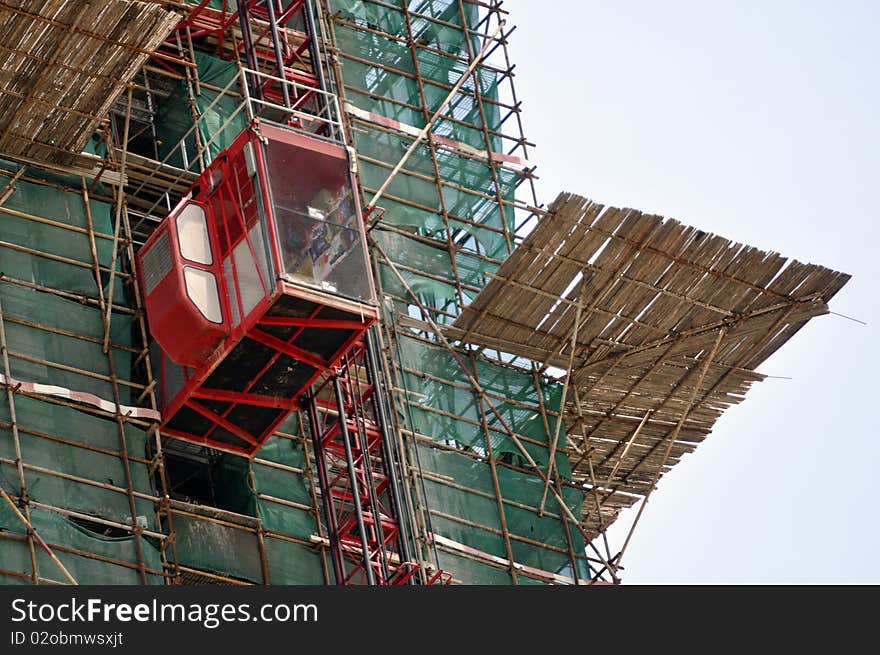 A skyscraper in construction phase with construction equipment on it