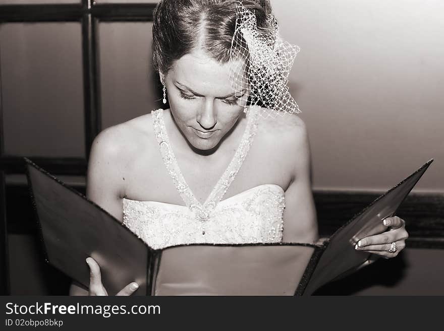 Bride in a restaurant about to enjoy her first meal as a married woman. Bride in a restaurant about to enjoy her first meal as a married woman.