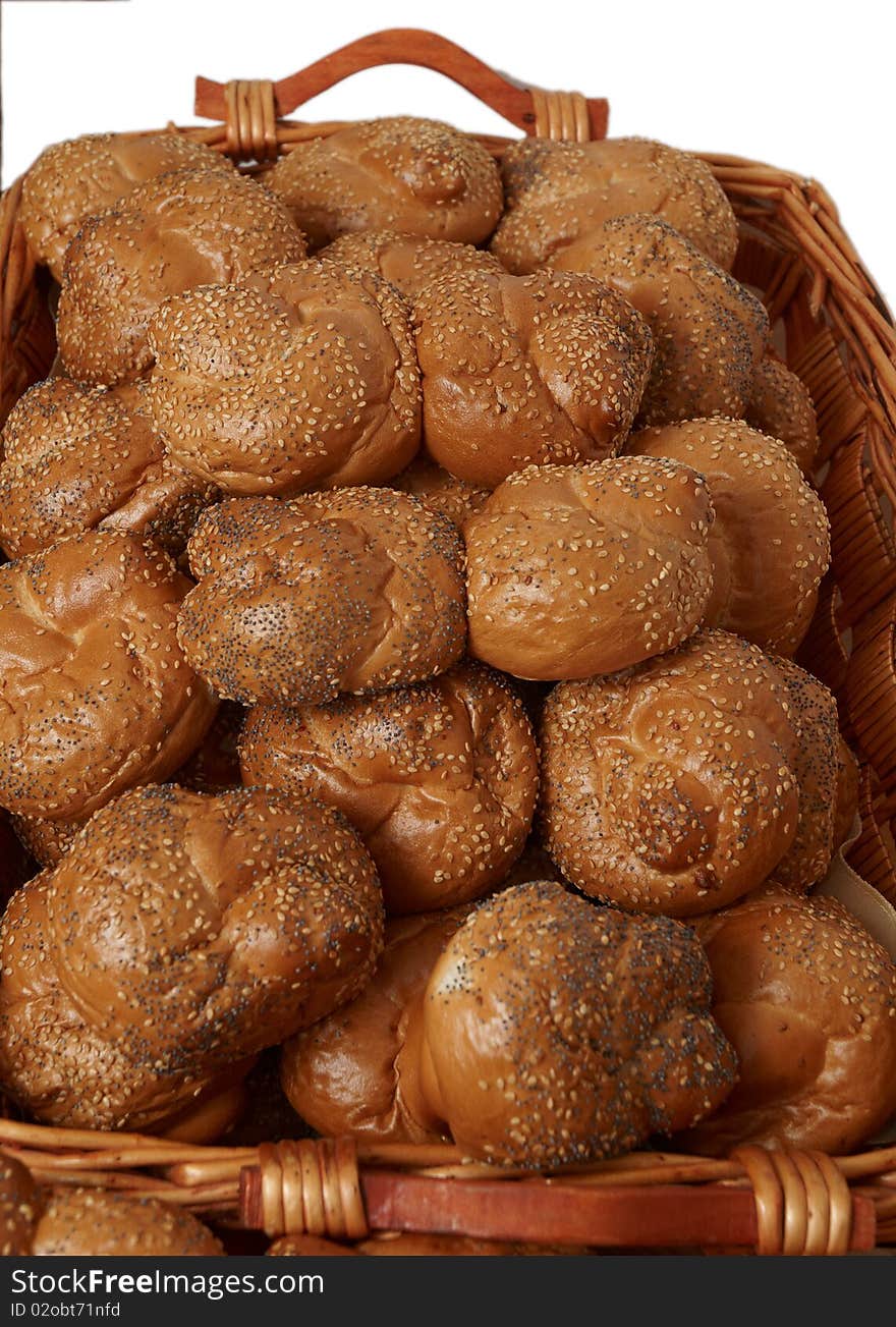 Fresh bread rolls in a wicker basket on a white background. Fresh bread rolls in a wicker basket on a white background.