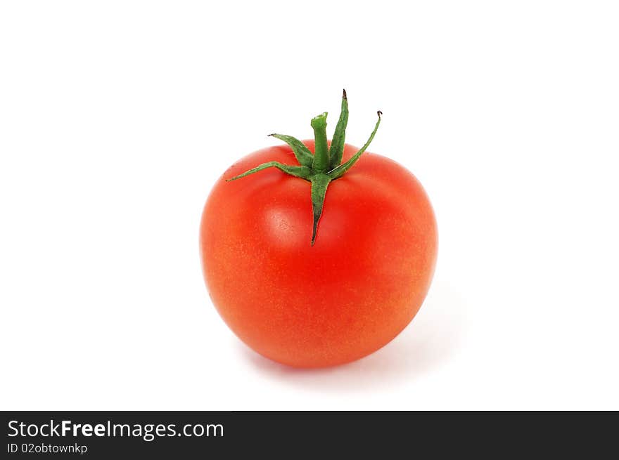 The tomato is isolated on a white background