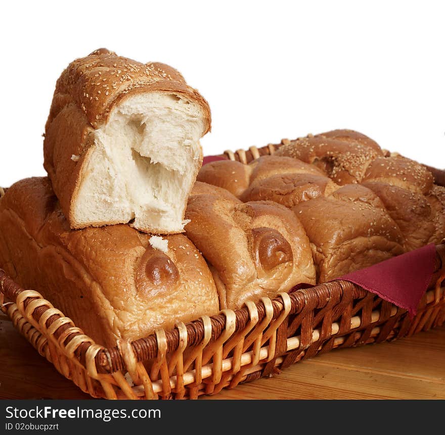 Fresh bread in a wicker basket on a white background . Fresh bread in a wicker basket on a white background .