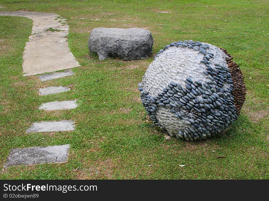 A sculptured ball and a stone. A sculptured ball and a stone