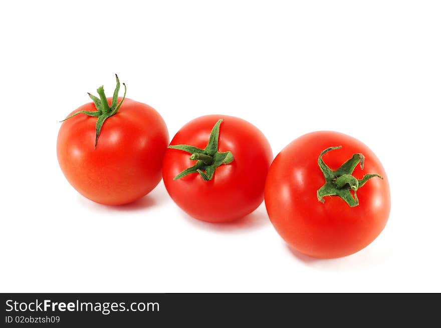 Three tomatoes are isolated on a white background