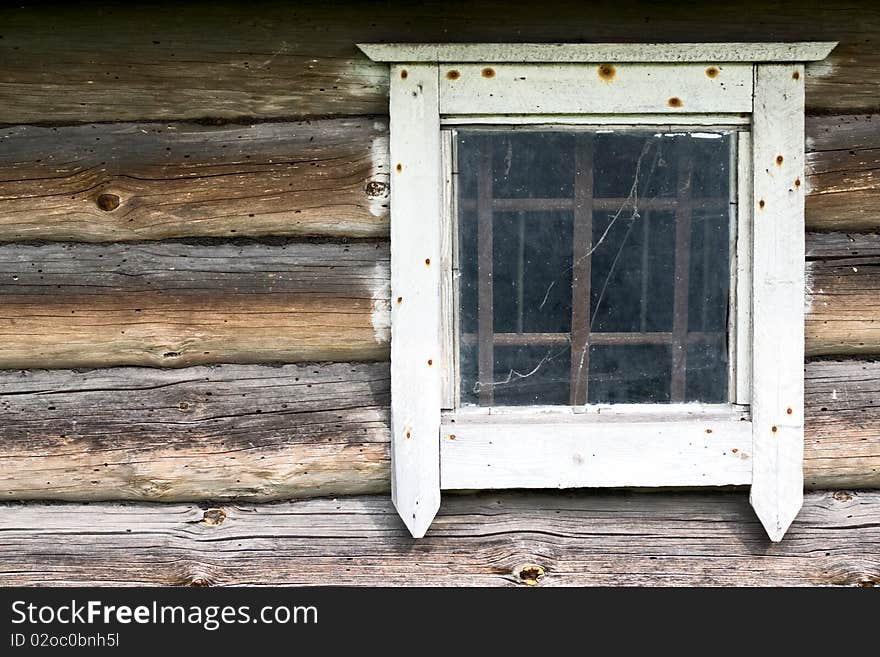 Old white window in a old wooden wall. Old white window in a old wooden wall
