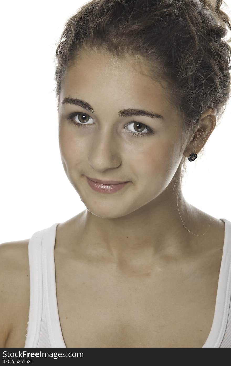 Portrait of the girl-teenager with a brown hair on a white background