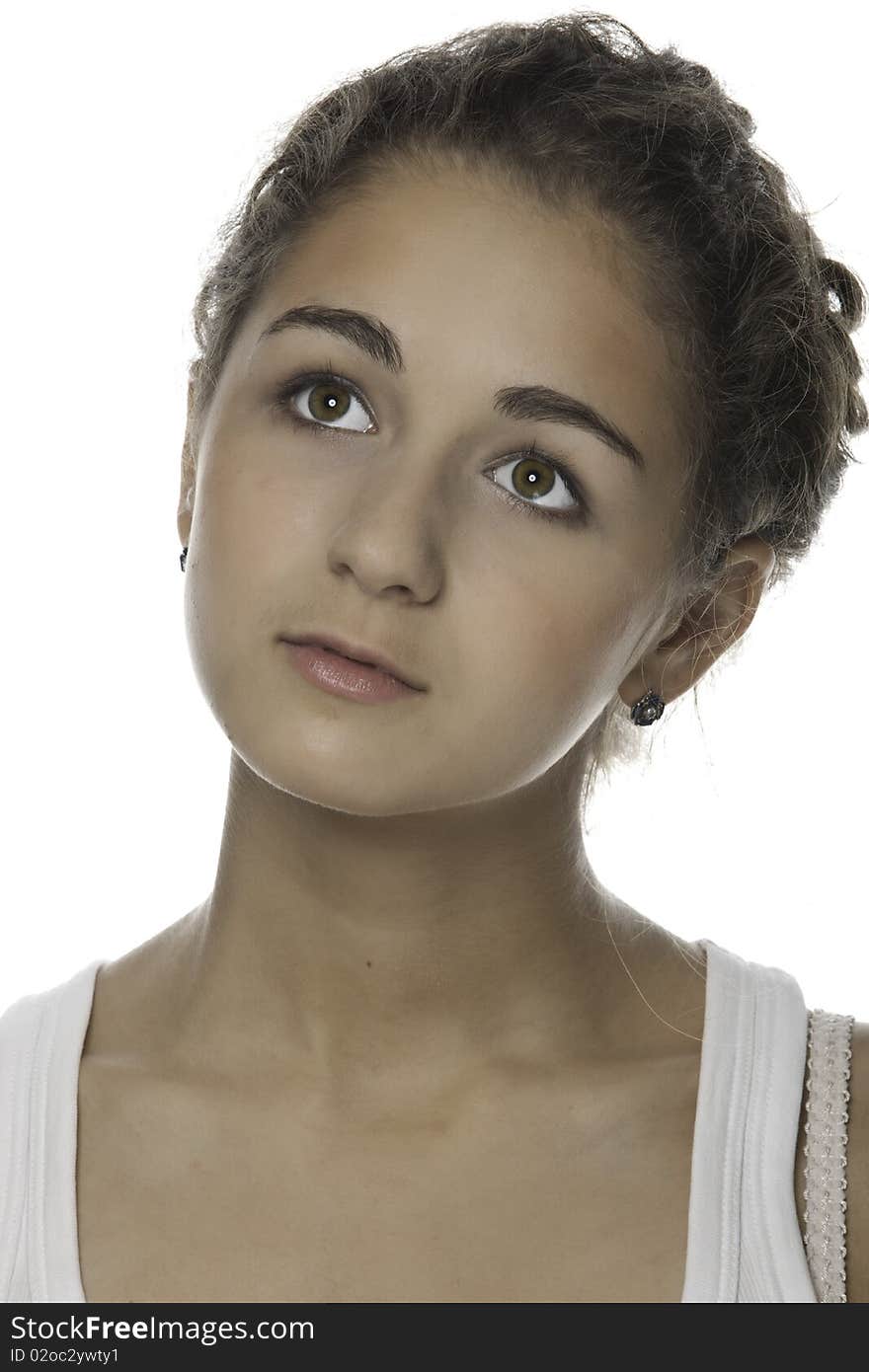 Portrait of the girl-teenager with a brown hair on a white background. Portrait of the girl-teenager with a brown hair on a white background