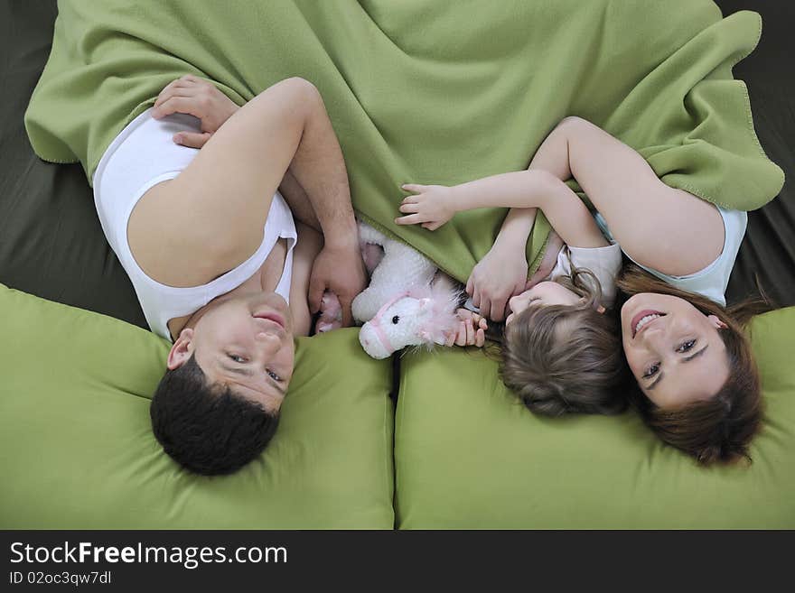 Happy family relaxing in bed