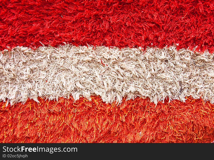 Close view of carpet texture colored on white and red