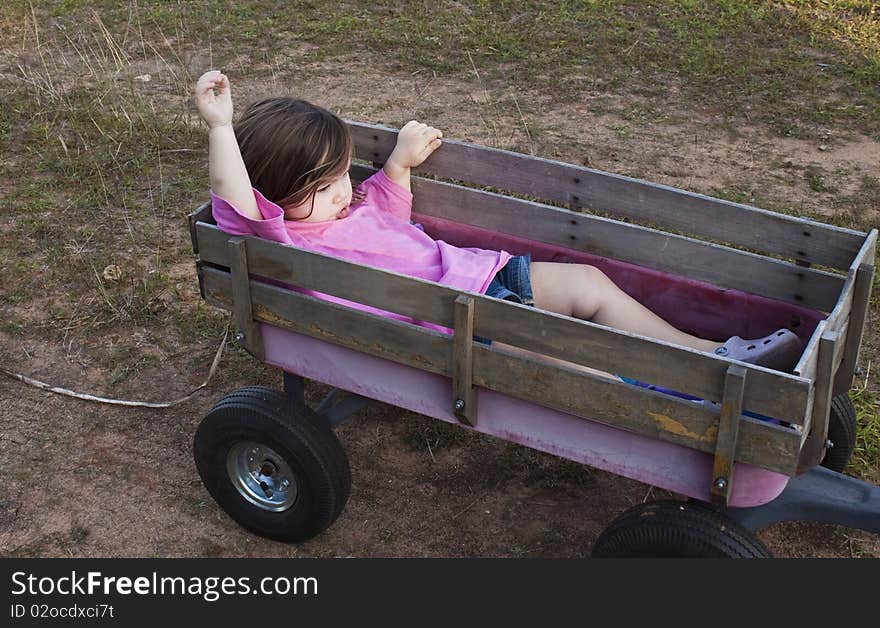 Girl in a wagon showing frustration